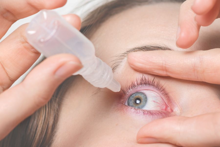 Female Pours Drops in Red Eye