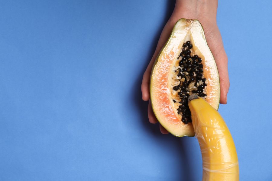Half of Sweet Papaya and Banana in Female Hands